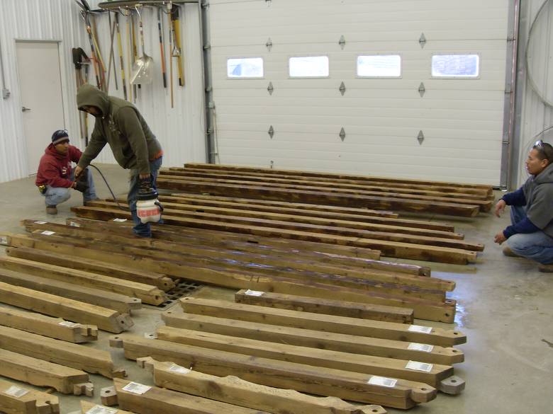 Camp Barn Restoration / Cannon Salvage workers cleaning, applying borate, and waxing the frame.